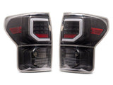 Raxiom 07-13 Toyota Tundra Axial Series Dual C-Shape LED Tail Lights- Black Housing- Clear Lens - TU9916