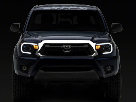 Raxiom 12-15 Toyota Tacoma Axial Series Projector Headlights w/ LED Bar- Blk Housing (Clear Lens) - TT21849