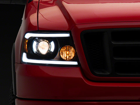 Raxiom 04-08 Ford F-150 Axial Series Projector Headlights with LED Bar- Black Housing- Clear Lens - T566363
