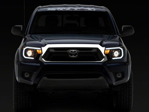 Raxiom 12-15 Toyota Tacoma Axial Series Projector Headlights w/ LED Bar- Blk Housing (Clear Lens) - TT21849