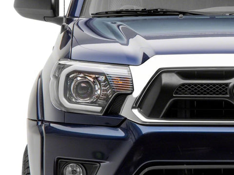 Raxiom 12-15 Toyota Tacoma Axial Series Projector Headlights w/ LED Bar- Blk Housing (Clear Lens) - TT21849