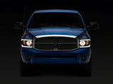 Raxiom 06-09 Dodge RAM 1500/2500/3500 Axial Headlights w/ SEQL LED Bar- Blk Housing (Clear Lens) - R131480
