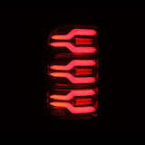 AlphaRex 19-21 Dodge Ram 1500 Luxx-Series LED Tail Lights Black/Red w/Activ Light/Seq Signal - 640050