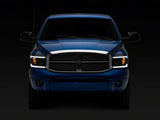 Raxiom 06-09 Dodge RAM 1500/2500/3500 Axial Headlights w/ SEQL LED Bar- Blk Housing (Clear Lens) - R131480