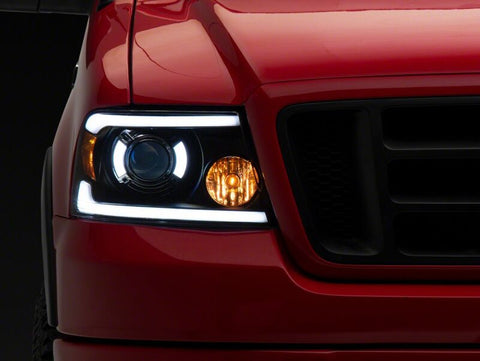 Raxiom 04-08 Ford F-150 Axial Series Projector Headlights with LED Bar- Black Housing- Clear Lens - T566363