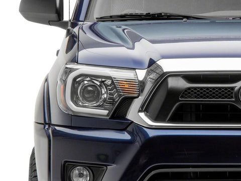 Raxiom 12-15 Toyota Tacoma Axial Projector Headlights w/ SEQL LED Bar- Blk Housing (Clear Lens) - TT21850